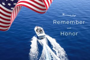 Featured image showing a speed boat on Lake Tahoe with an American Flag waving above. The words "Memorial Day, Remember and Honor " across the image.