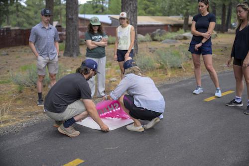 Featured image showing representatives of the Trail Etiquette Stencil Initiative stenciling reminders on Truckee Trails.